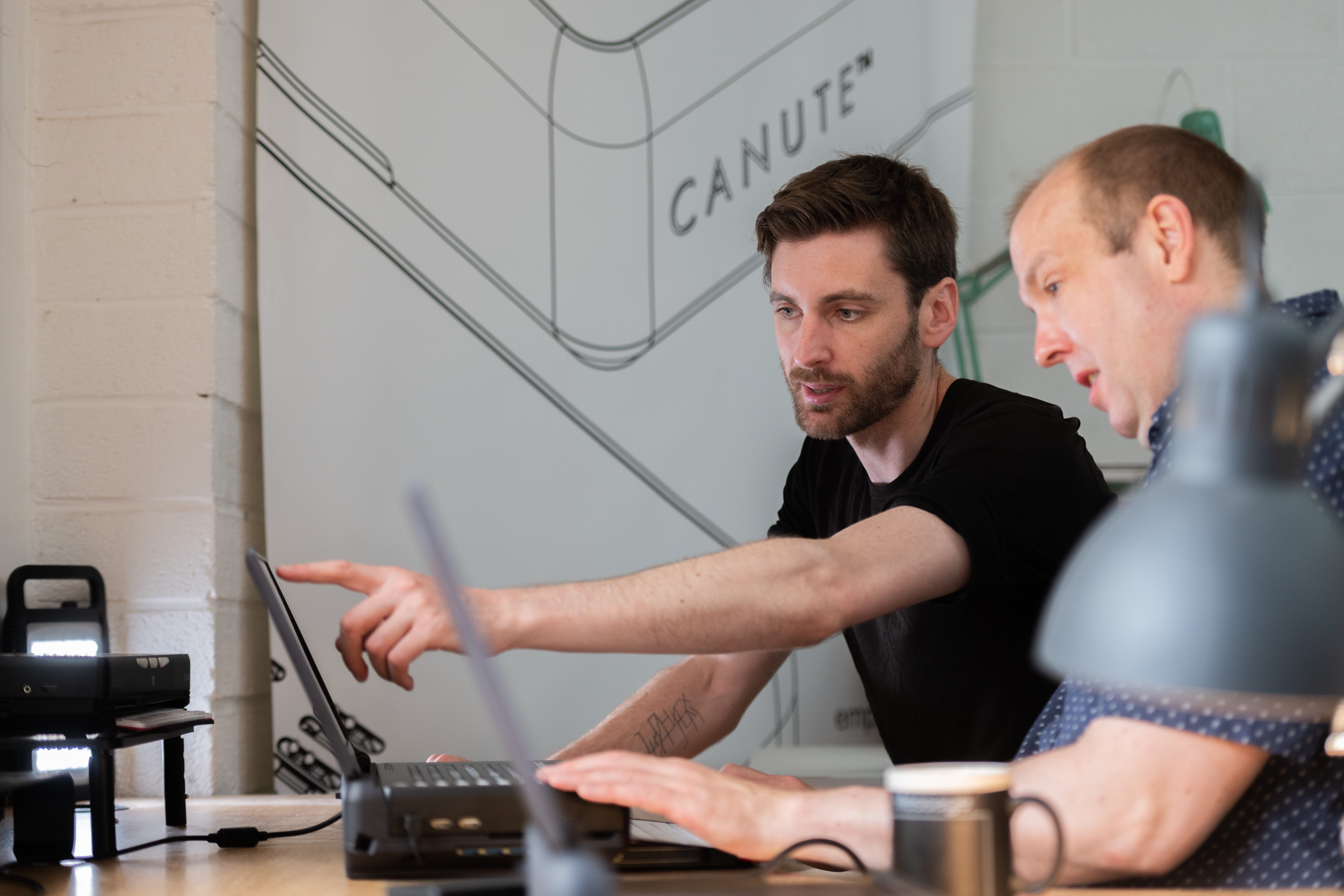 Two People, one sighted and one visually impaired, working together on the console
