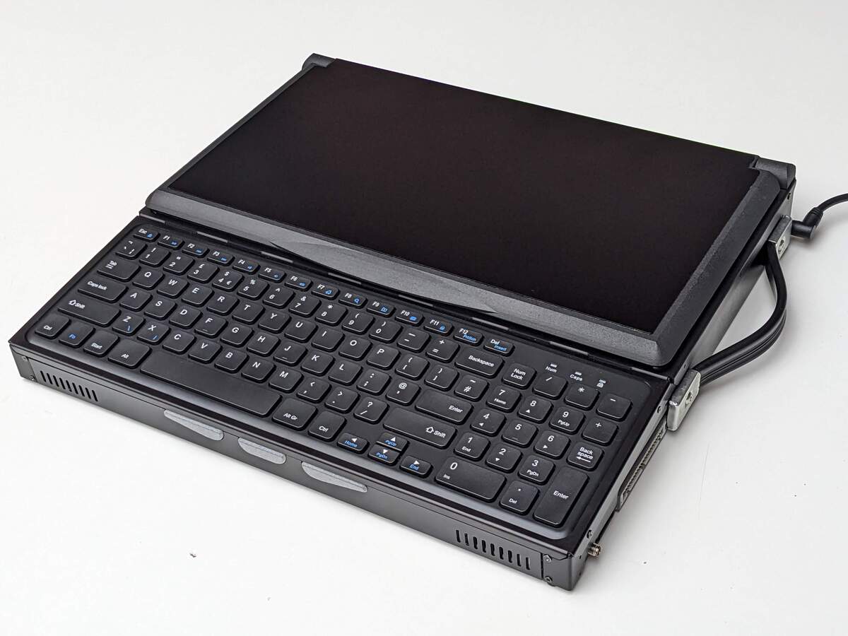 Three quarters profile photo of the Canute Scientific when closed. A full size keyboard in the front with a closed lid behind it.